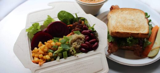 An image showing fresh vegetable salad and bread toast on the table with a white background.