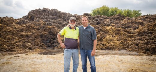 Two men standing in front of Honest Potato farm