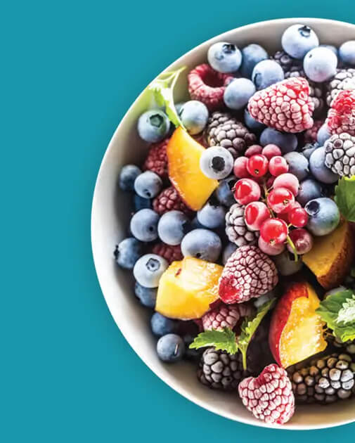 An image shows chopped fruits in a bowl: blackberries, red apples, and strawberries.